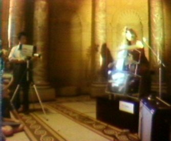 Paik and Moorman during a performance of the TV Cello in the entrance hall of the AGNSW (video still from photograph: Stephen Jones)